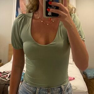 Green bodysuit with puffy sleeves.